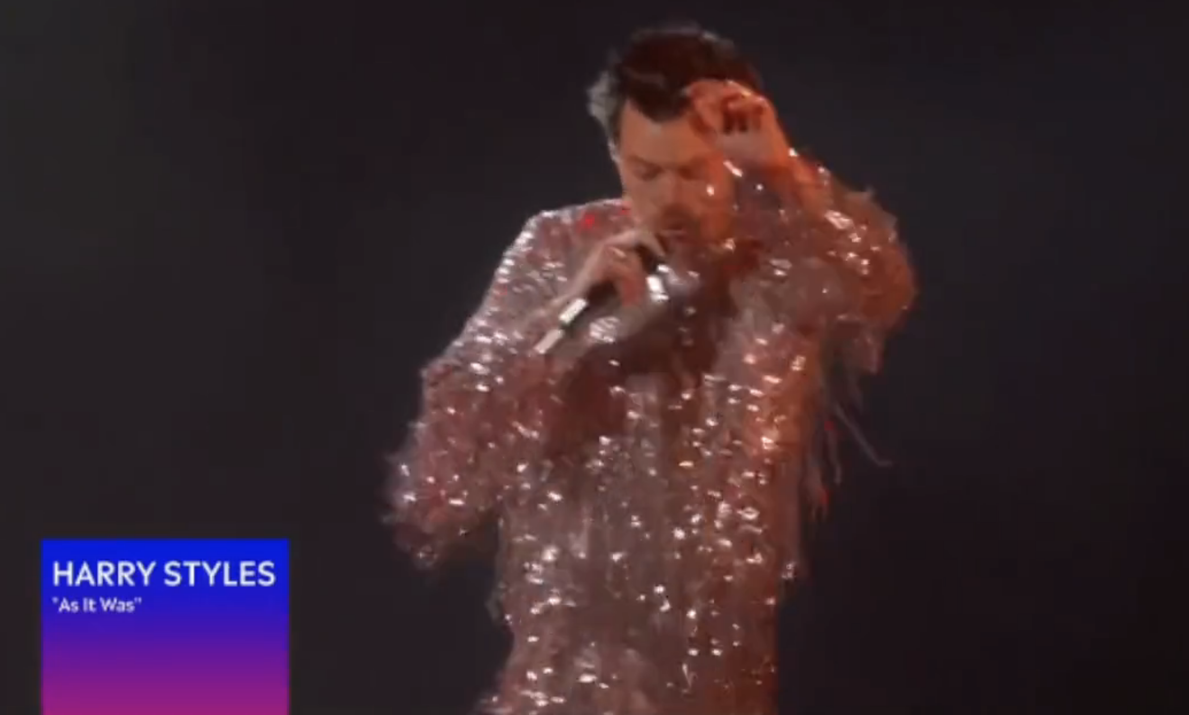 A screenshot of Harry in his sparkly outfit performing