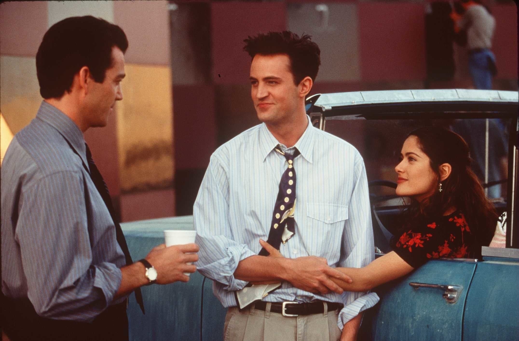 Jon Tenney looking at Matthew Perry and Salma Hayek as they hold each other in &quot;Fools Rush In&quot;