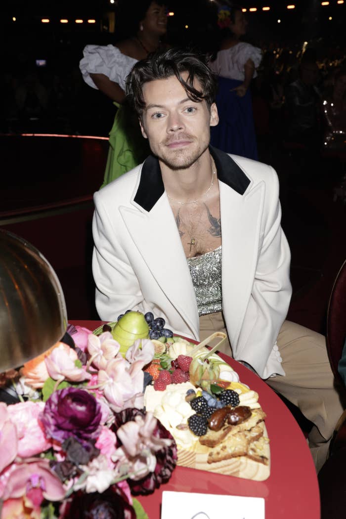 Harry Styles sits at his table during the Grammys