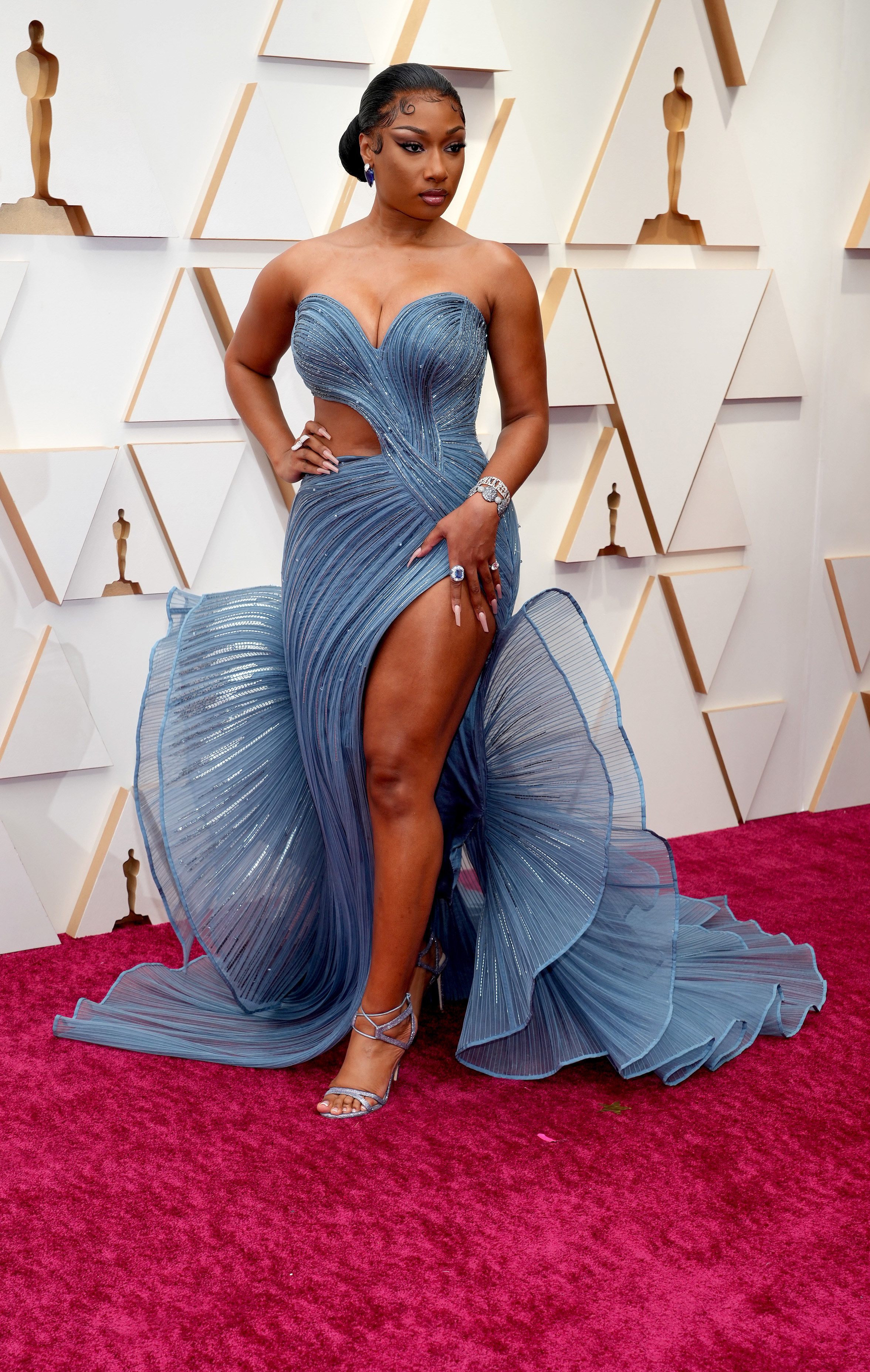 A side-view of Megan Thee Stallion in her gown