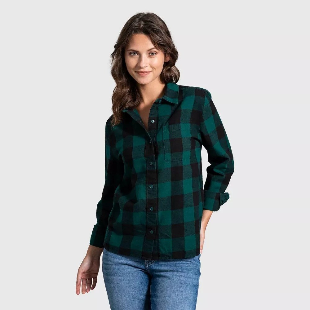A model wearing the green flannel shirt with blue jeans
