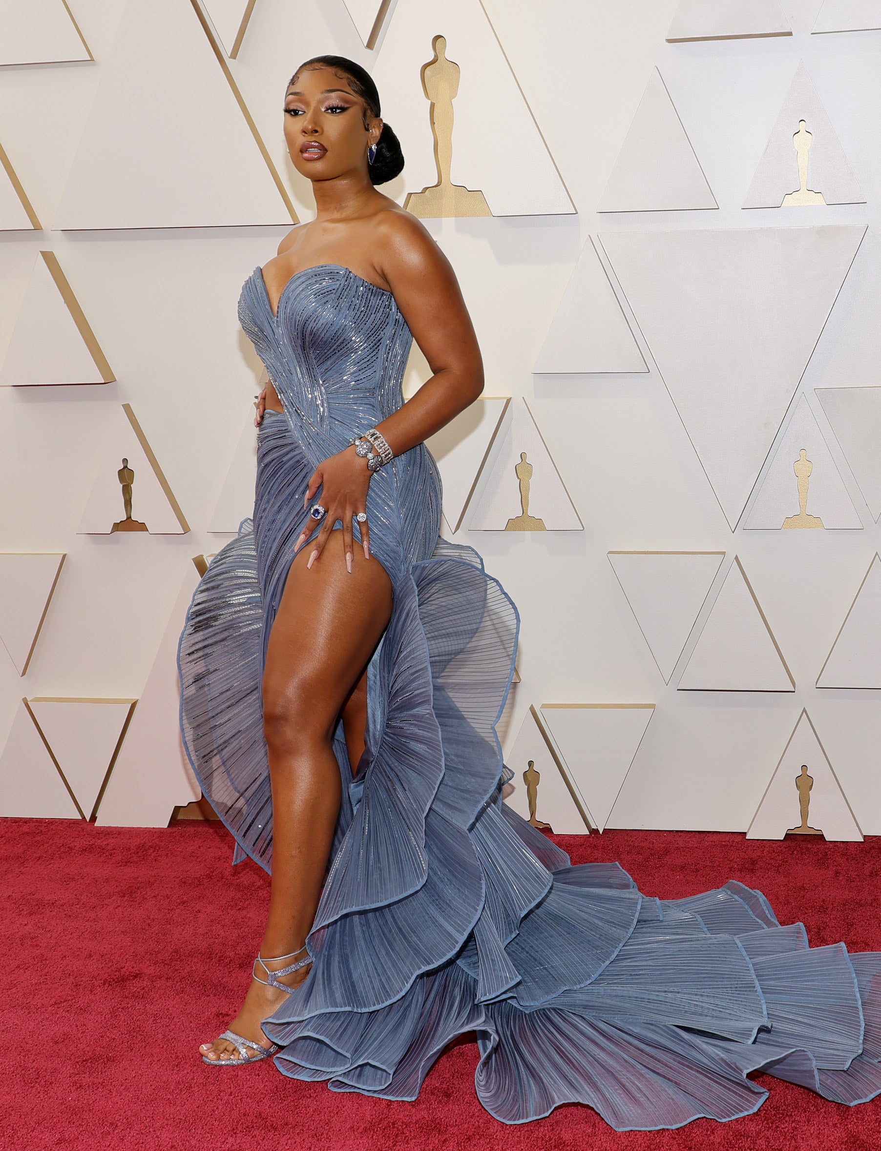 Megan Thee Stallion attends the 94th Annual Academy Awards in a strapless ruffled dress with a sweetheart neckline and a thigh-high slit