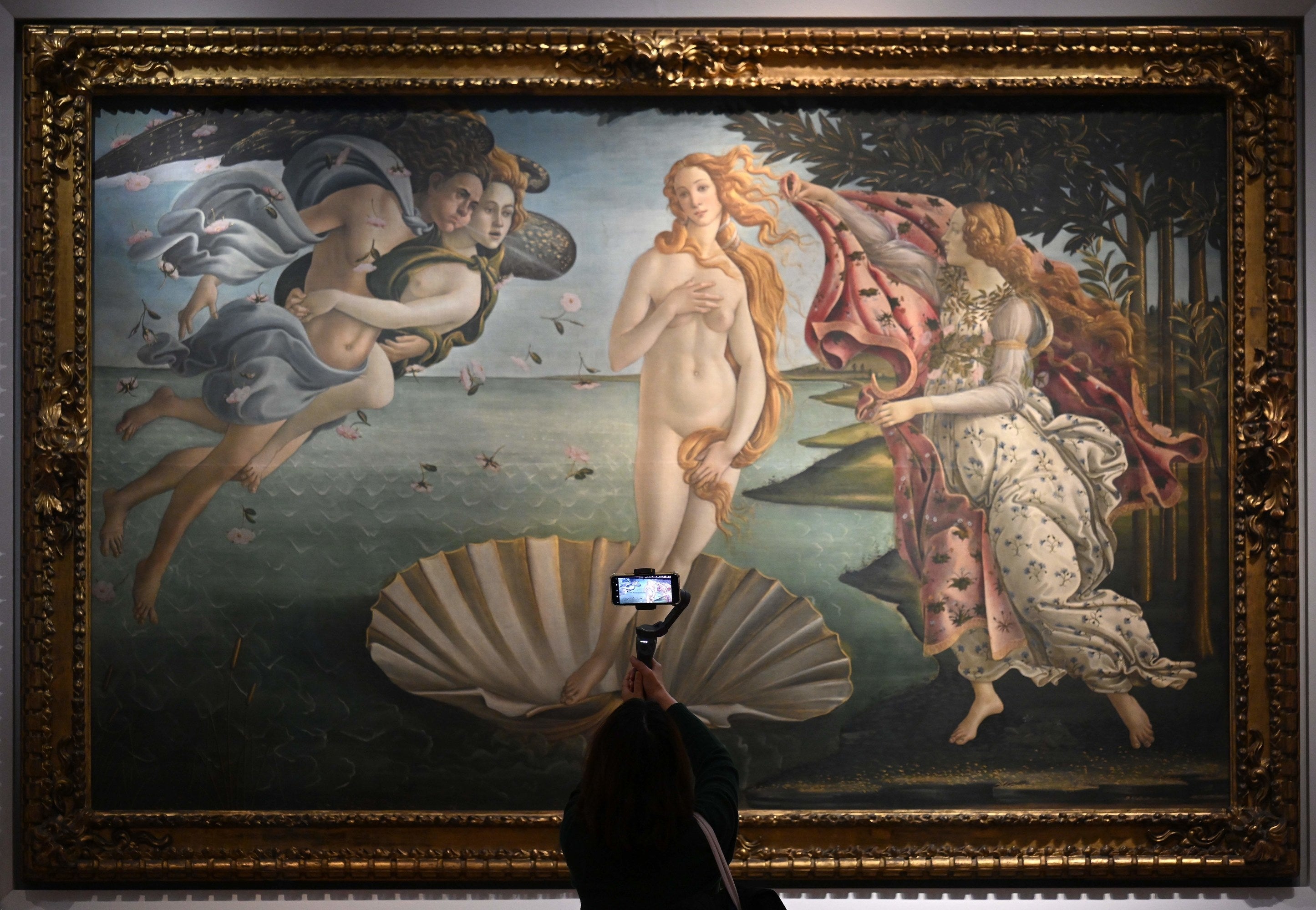 A visitor takes a video with her smartphone of Sandro Botticelli&#x27;s &quot;The Birth of Venus&quot; at the Uffizi Galleries in Florence, Tuscany