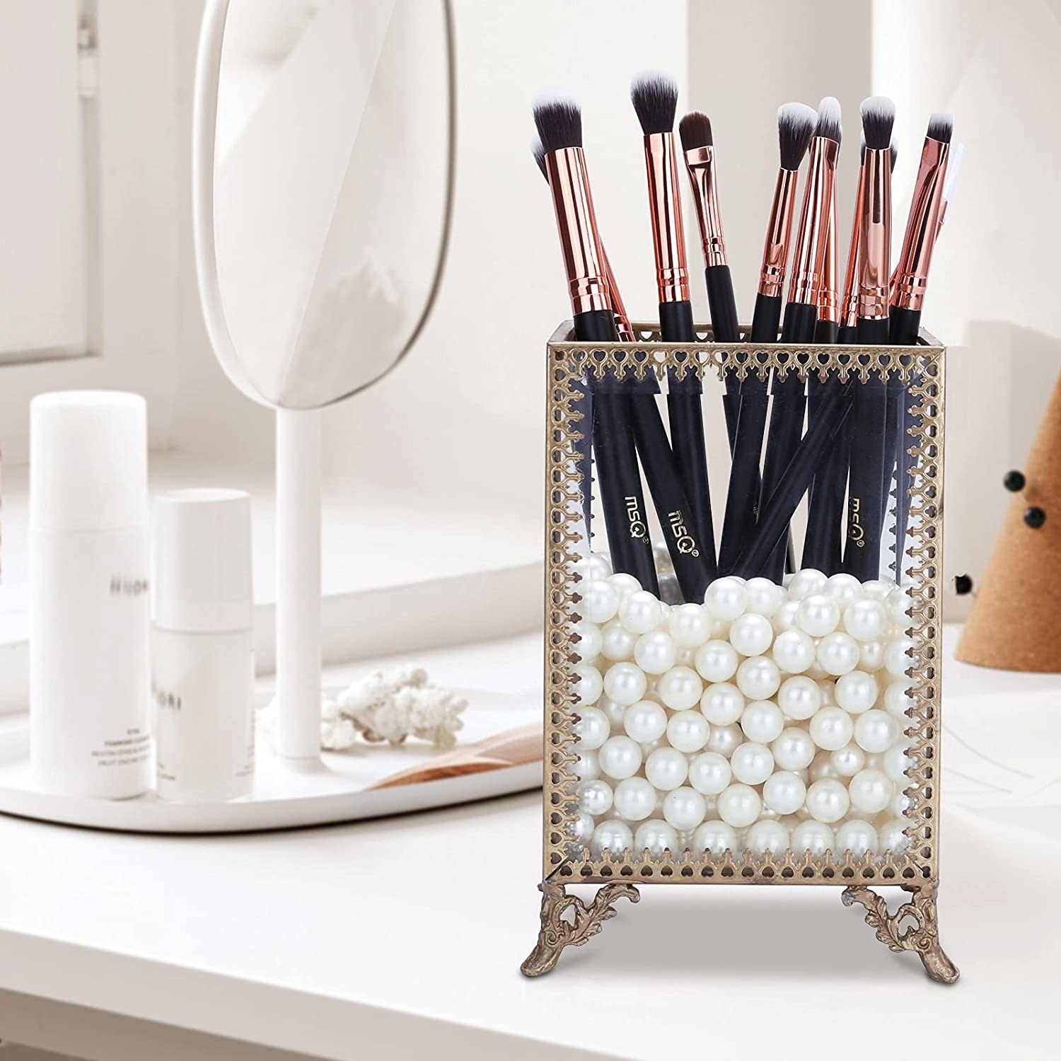 the brushes in a holder with pearl balls