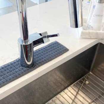 drip catcher placed around kitchen sink's faucet