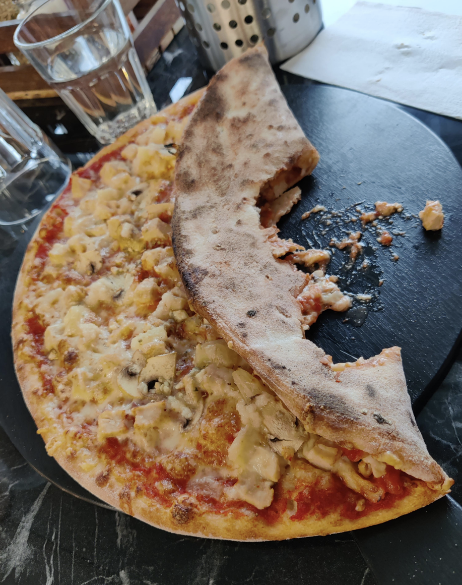 A pizza folded and bitten