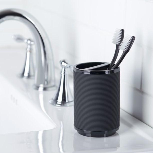 the toothbrush holder with two brushes in it