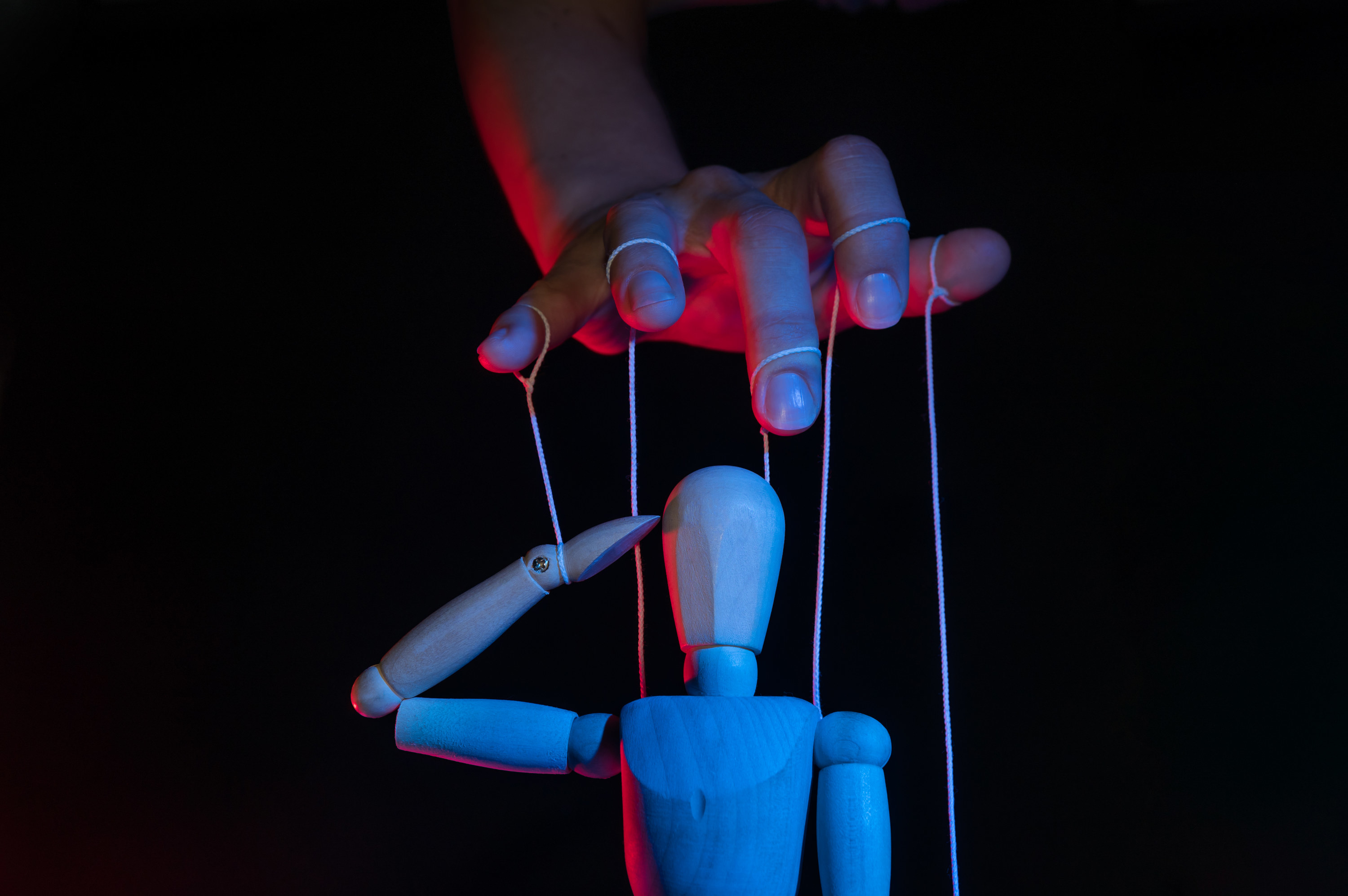 hand controlling a marionette