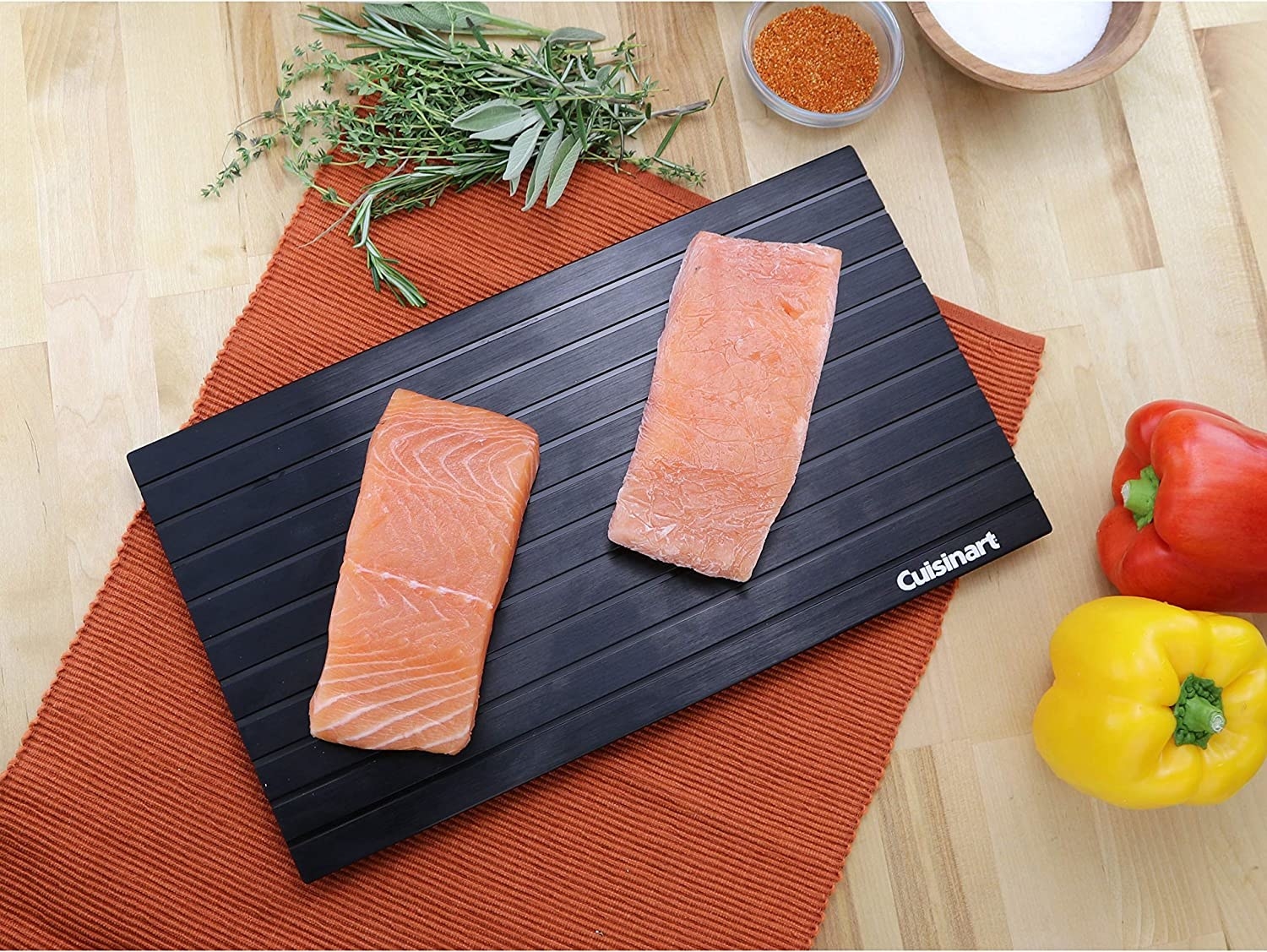 A picture of a defroster and cutting board with a slab of raw meat on it