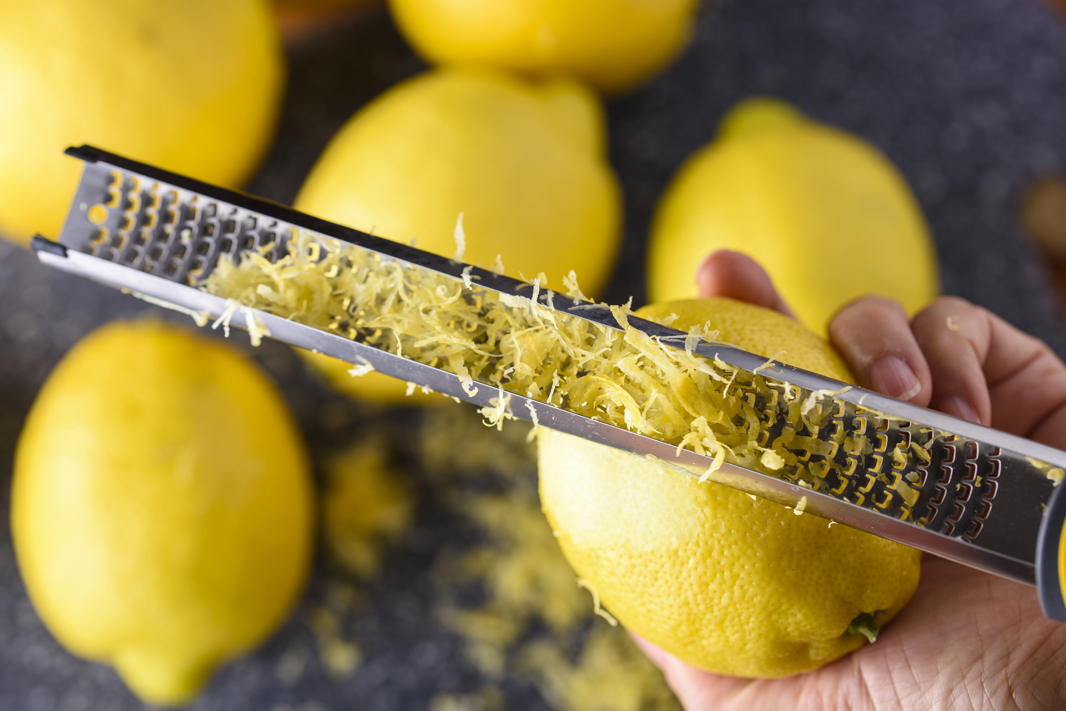 Hand zesting lemon.