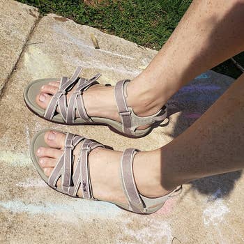 a reviewer wearing the same sandals in tan with mauve straps