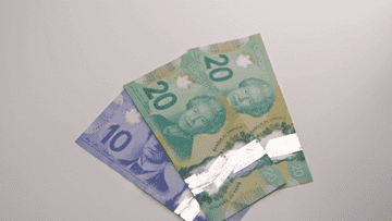 canadian money falling on table