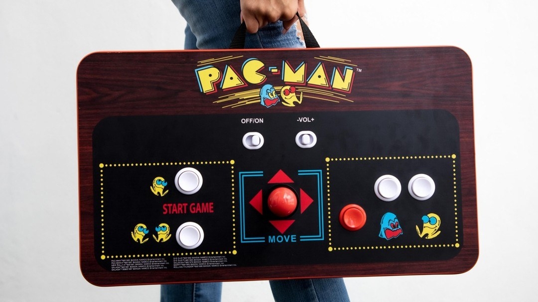 a person carrying the portable pac-man console deck