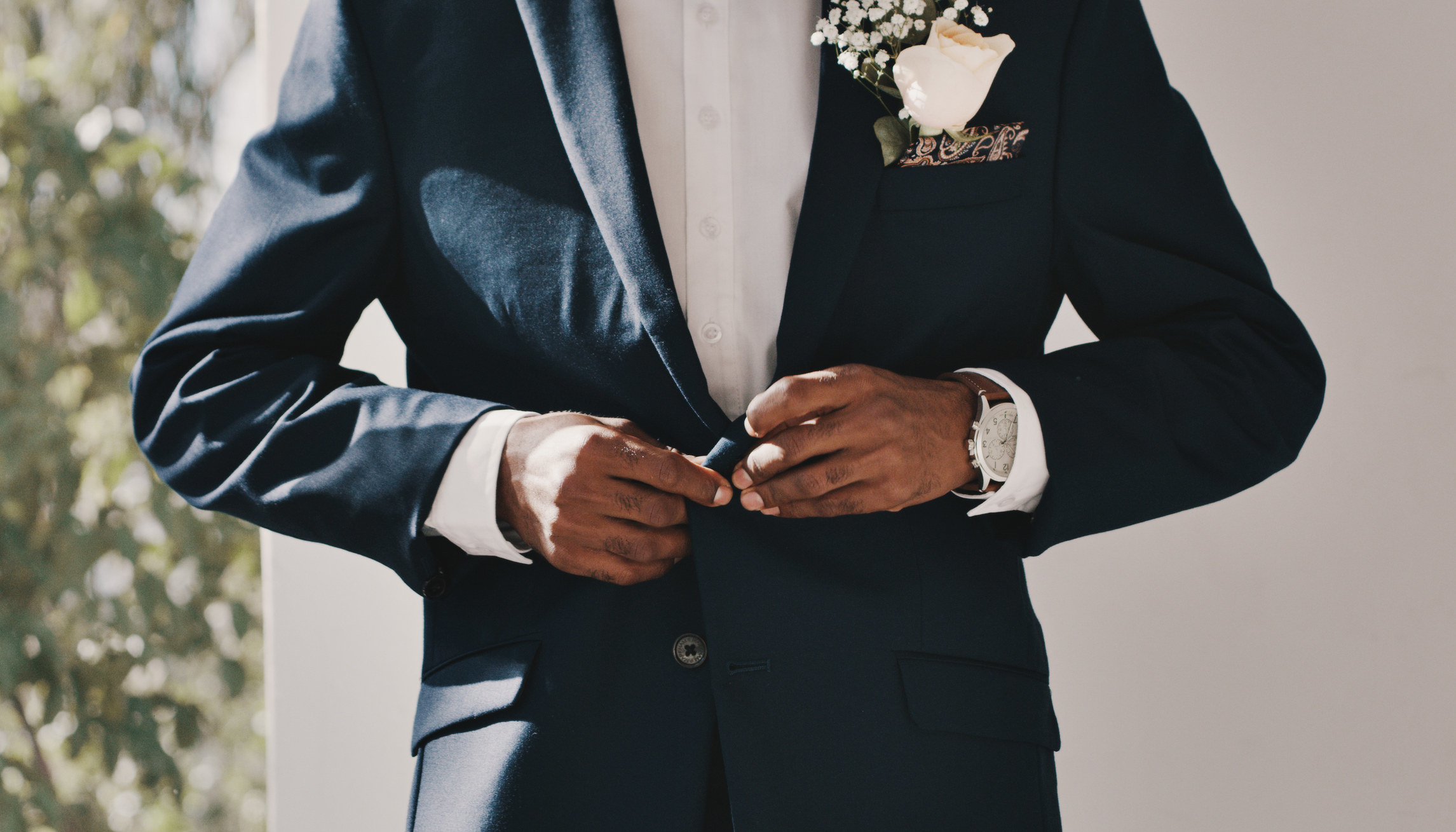A man buttoning his suit