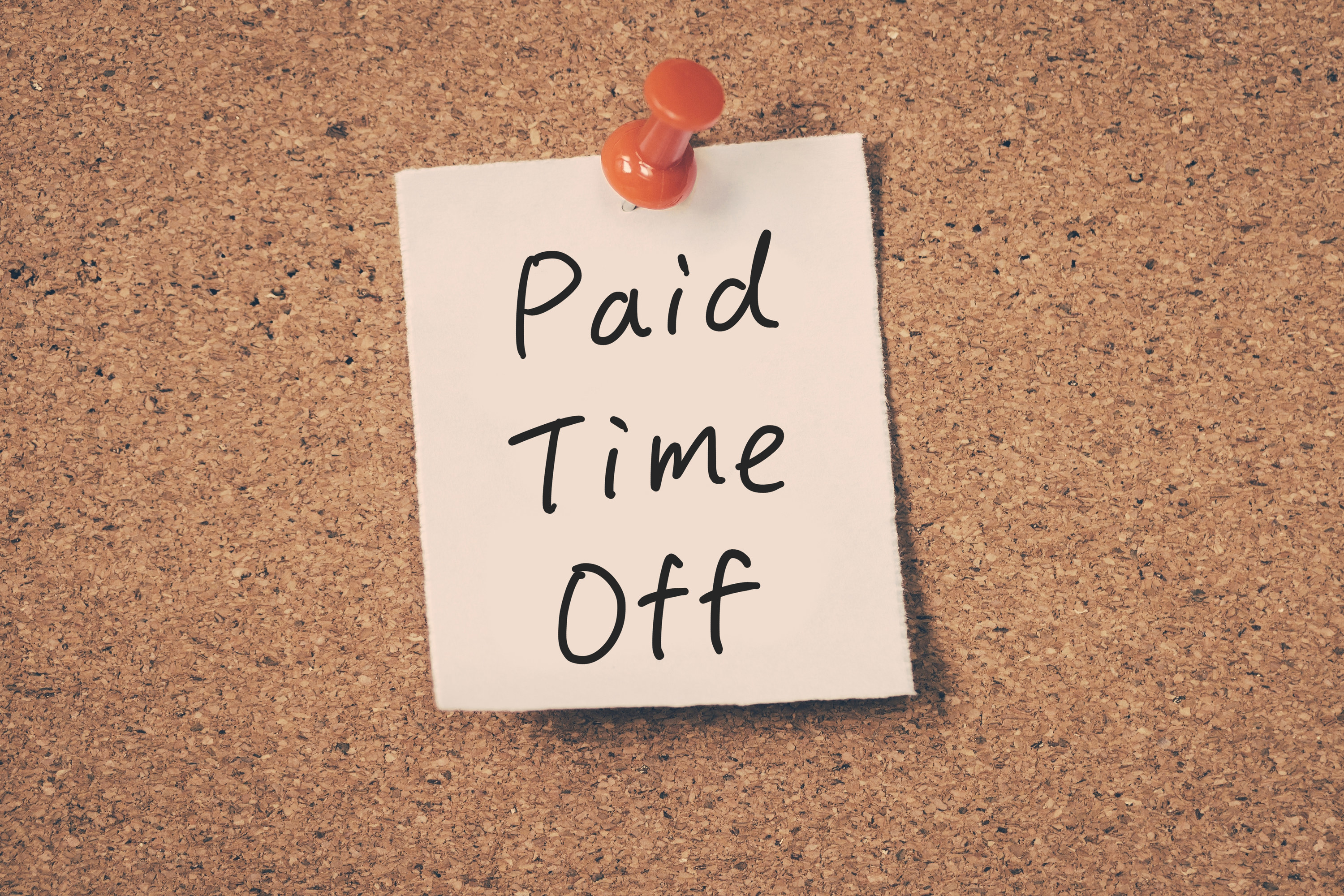 A pinned paper reading &quot;Paid Time Off&quot;