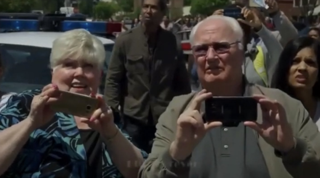 His parents holding up cellphones