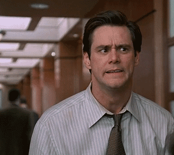 gif of Jim Carrey as Fletcher in the film &quot;Liar Liar&quot; making a scary face