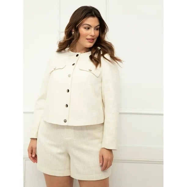 Model wearing cream jacket and shorts set