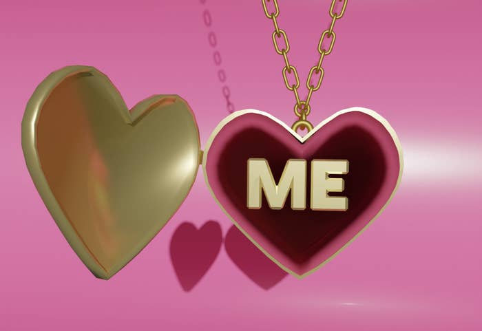 A gold heartshaped locket with that says &quot;ME&quot; on the inside on pink velvet
