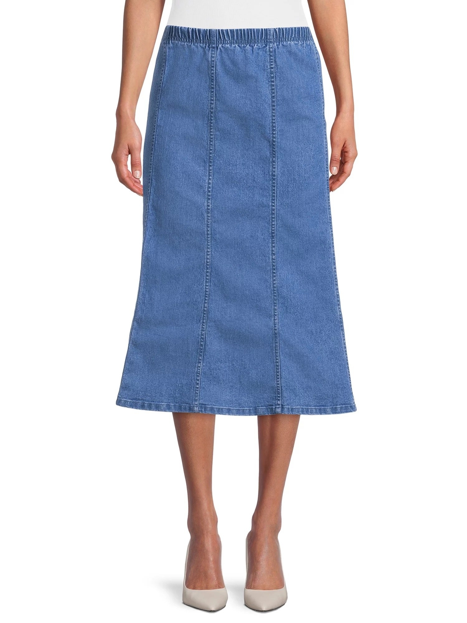 Model wearing mid wash denim skirt with white shirt and shoes