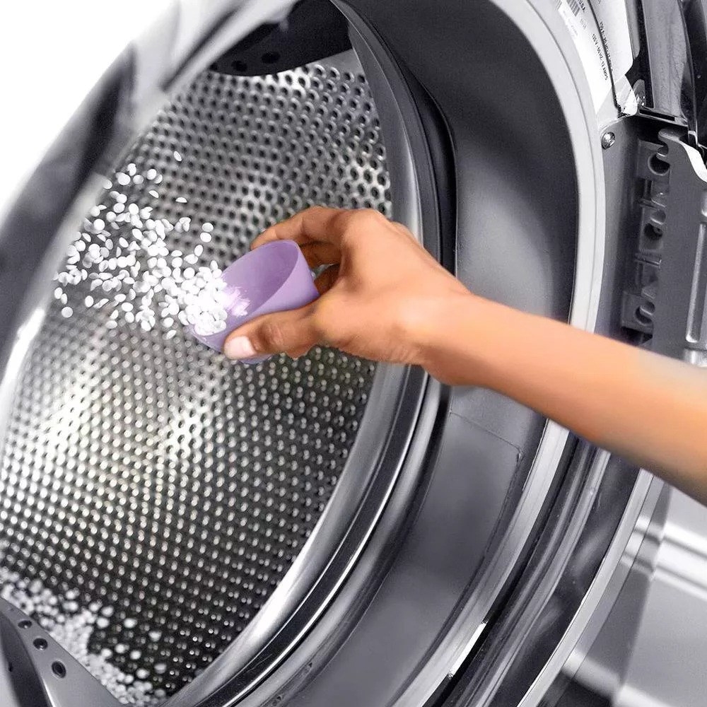 Person putting the boosters in washing machine