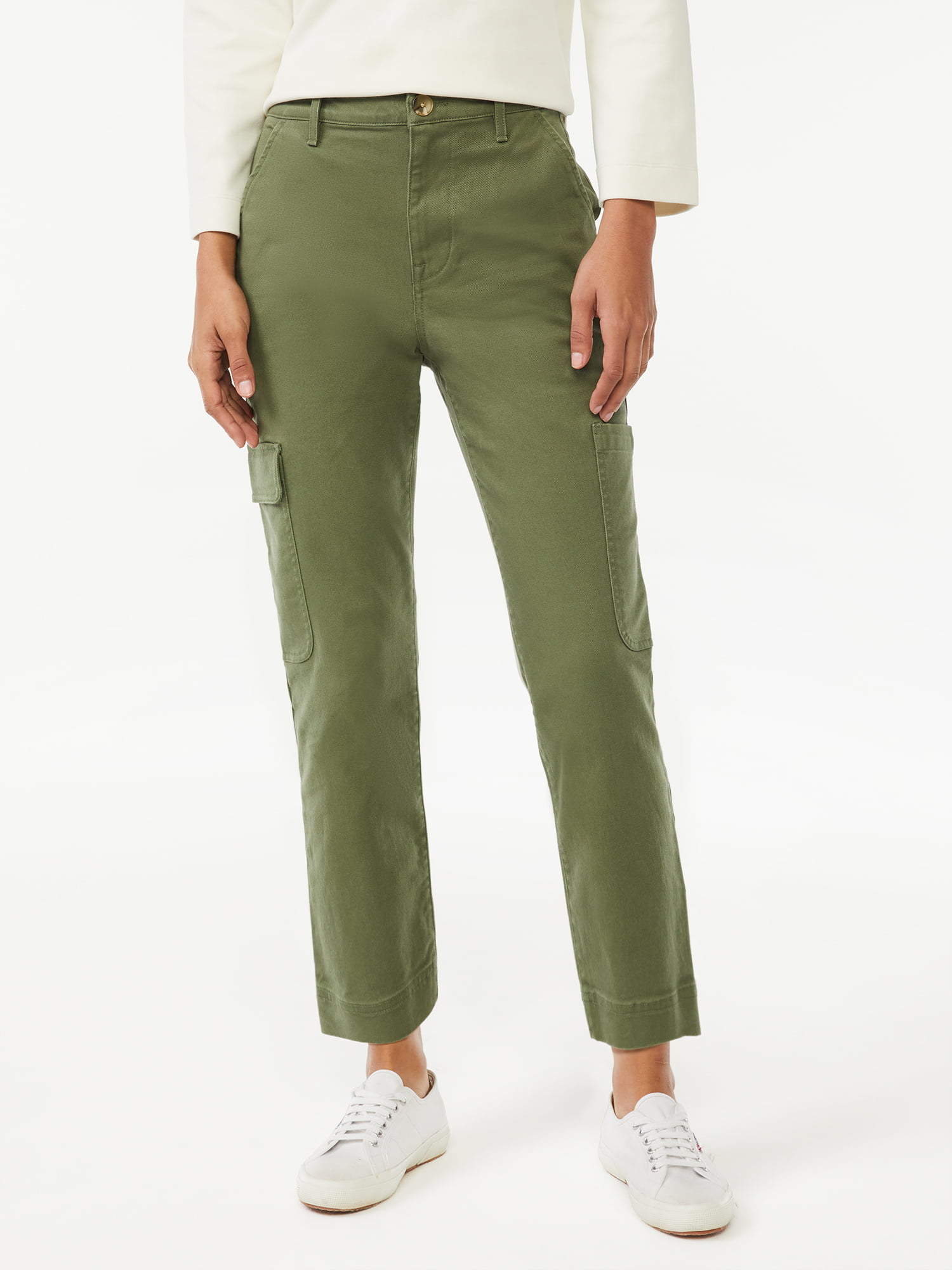 Model wearing white top and sneakers with green cargo pants