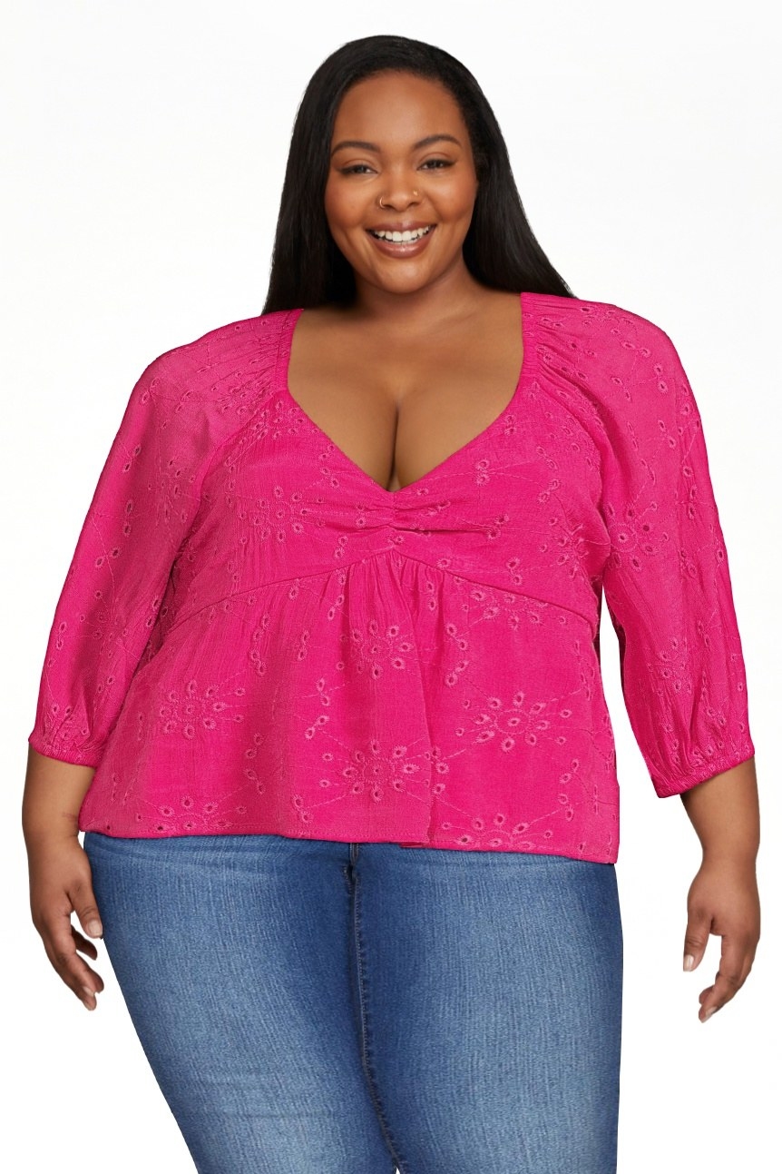 Model wearing pink top with jeans