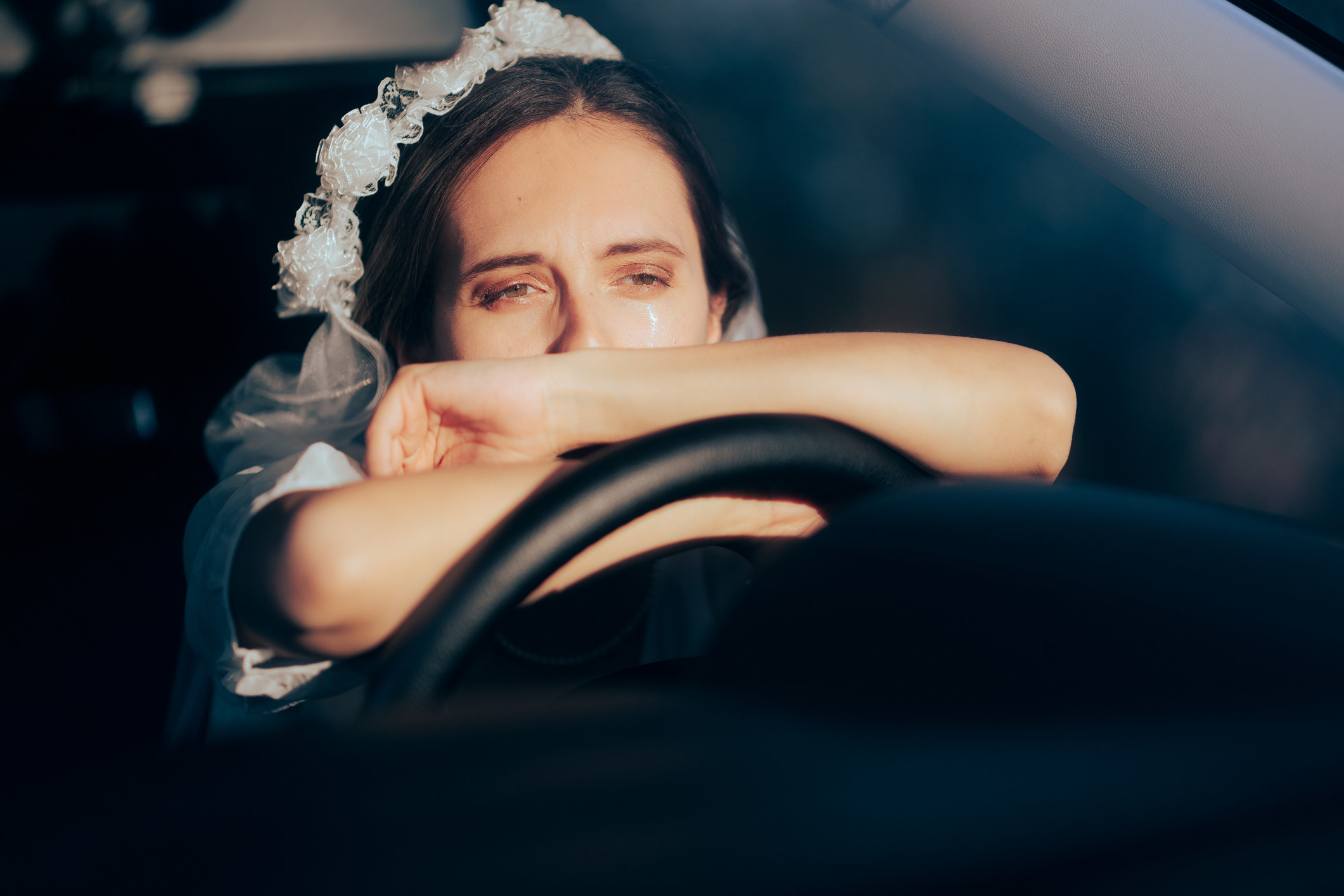 A bride crying in a car
