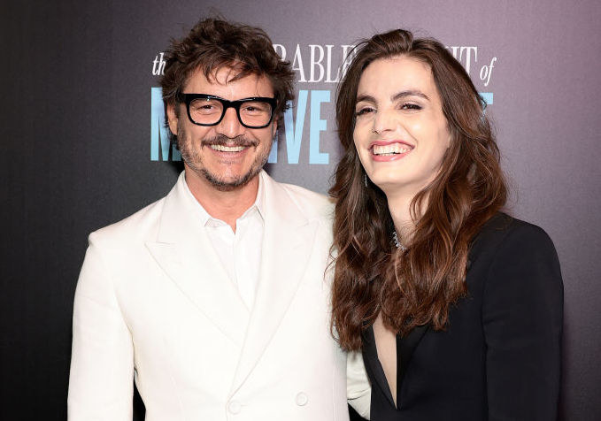 Pedro and Lux smile as they pose together on the red carpet