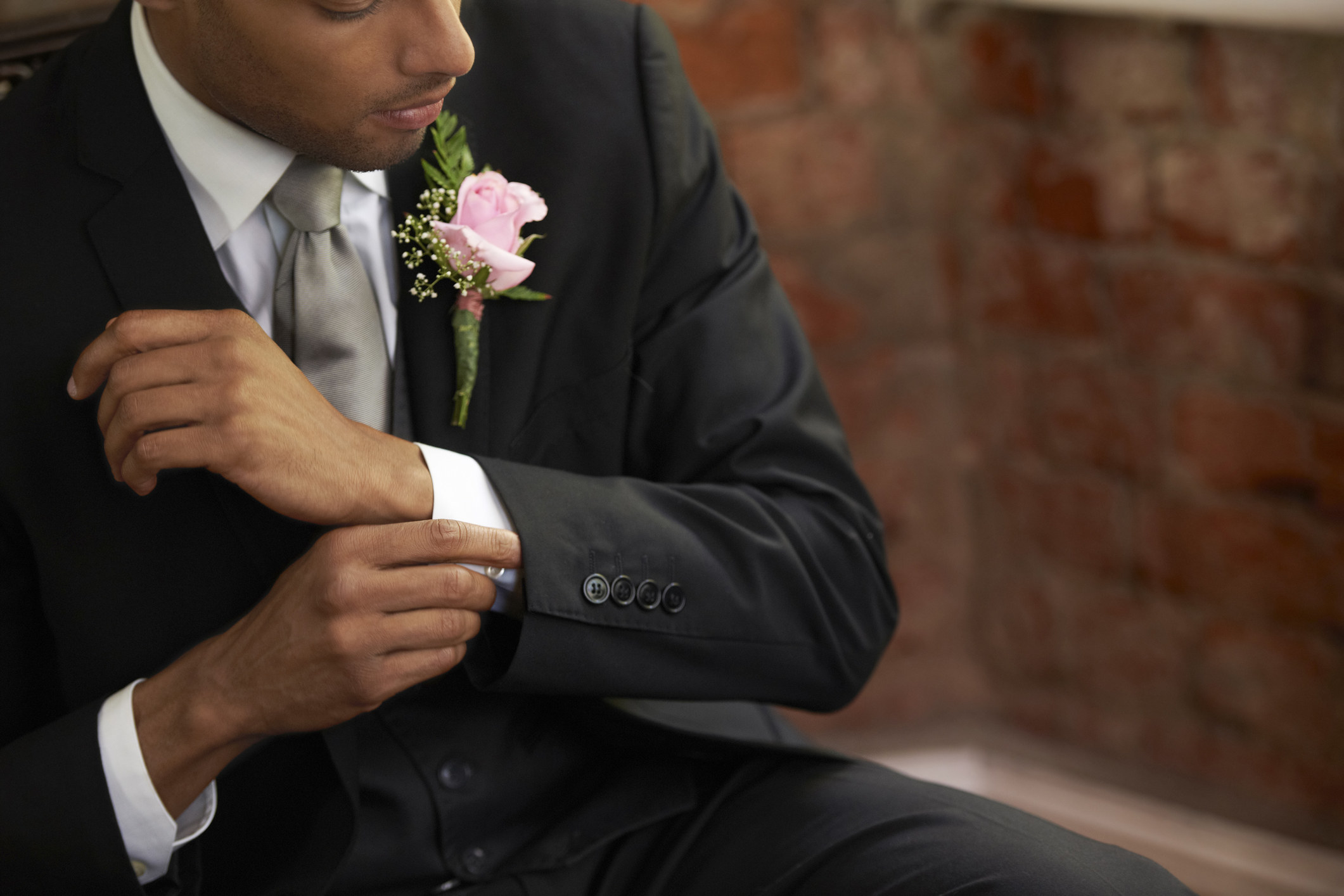A groom fixing his cuff
