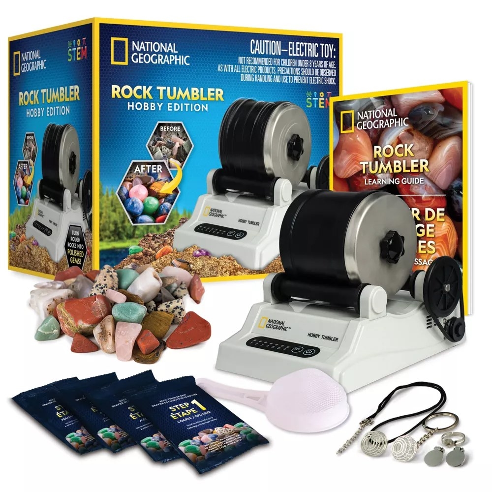 White, black, and metal rock tumbler with rocks, packets, as well as the packaging