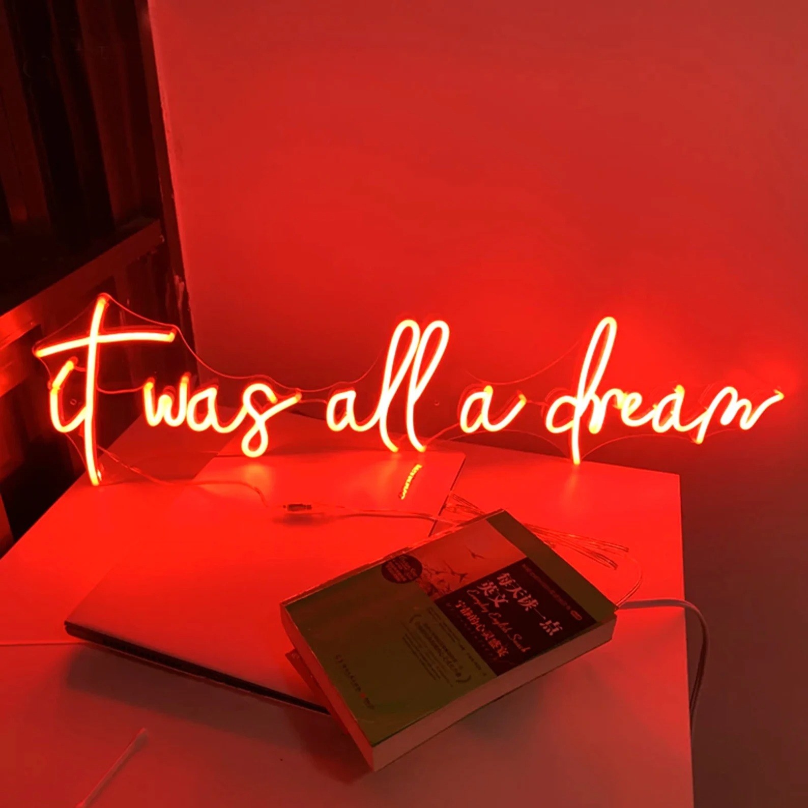 A red neon sign says &quot;it was all a dream&quot;