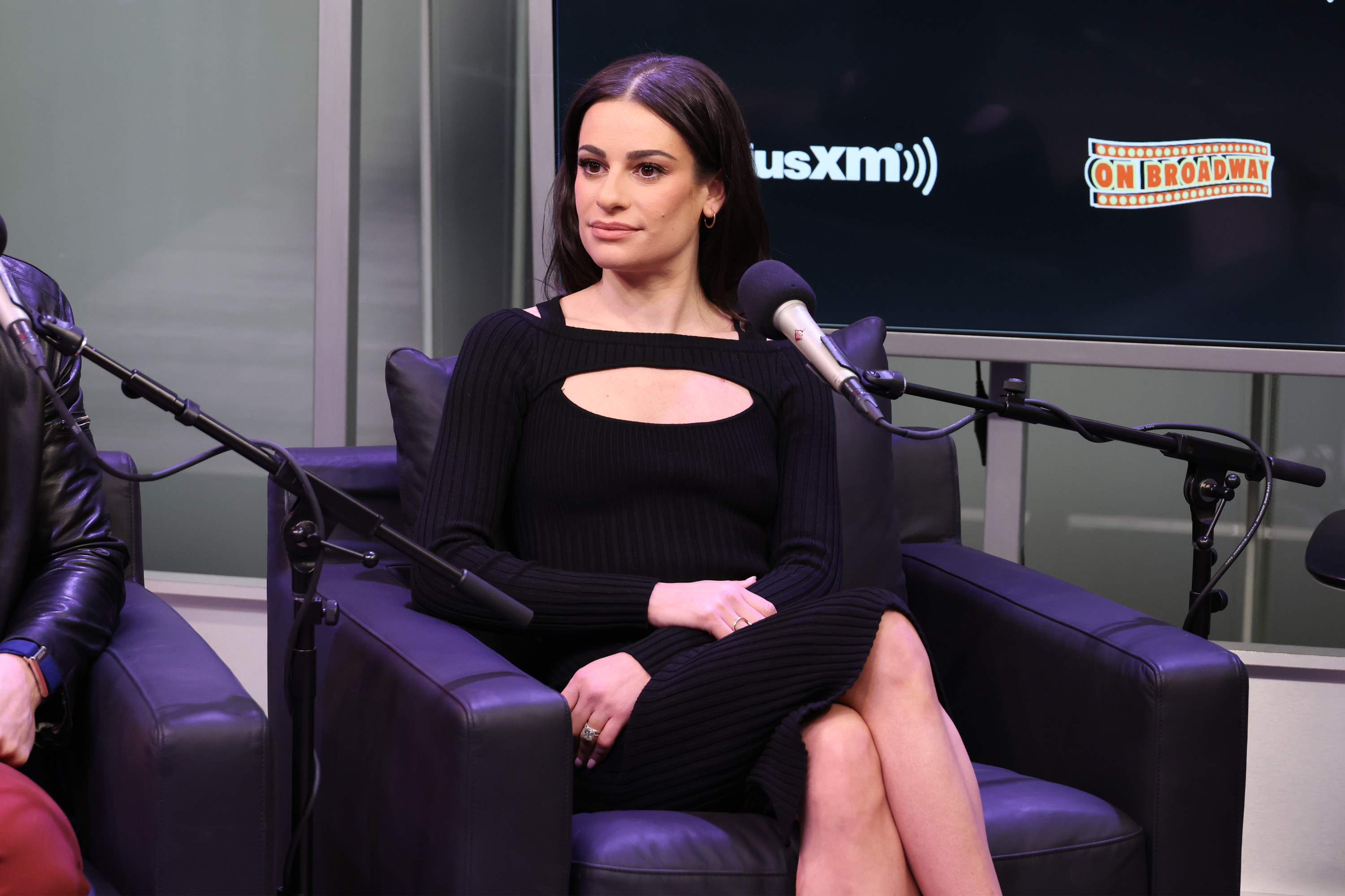 Lea looks to the side as she sits during a podcast interview