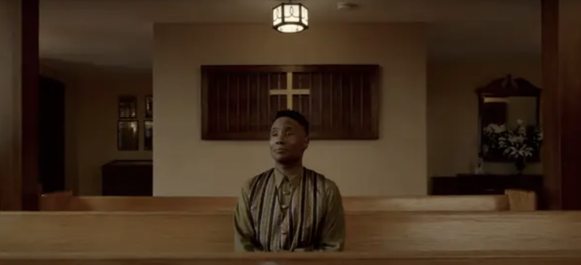Black man sitting alone in a church pew