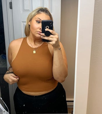 reviewer wearing the brown cropped tank