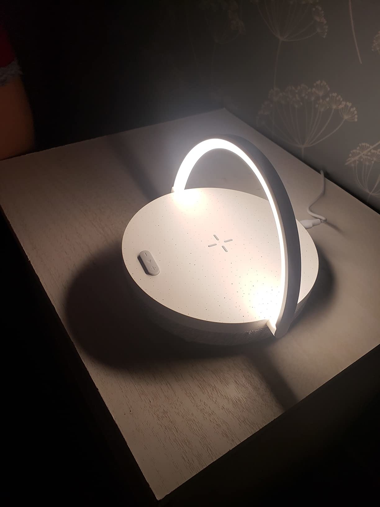 a reviewer&#x27;s lamp on a nightstand