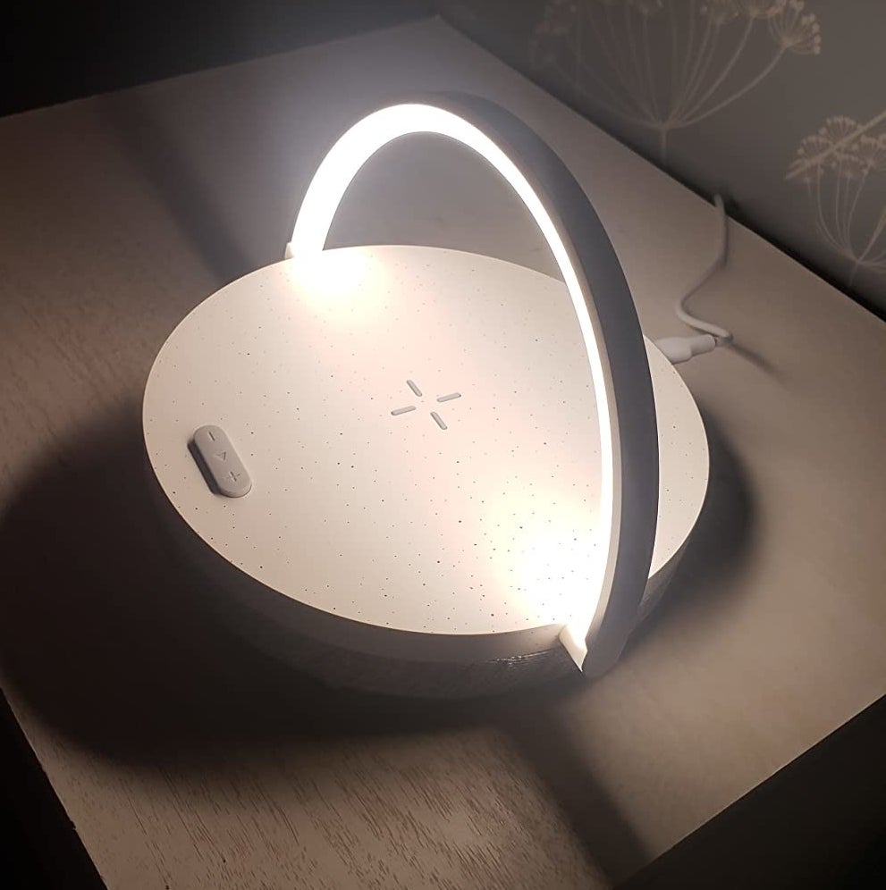 a reviewer&#x27;s lamp on a nightstand