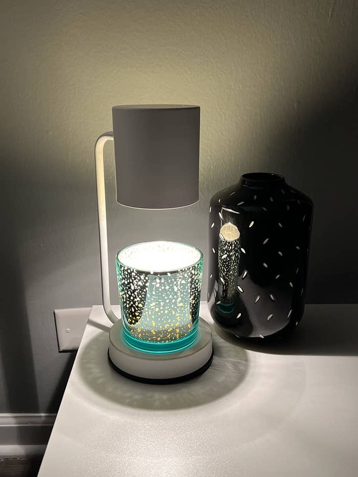 a reviewer&#x27;s candle warmer on their bedside