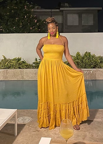 reviewer wearing mustard dress