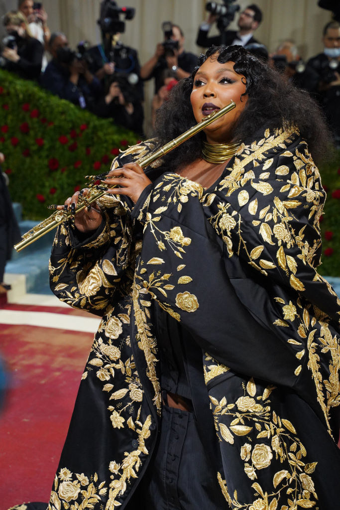 Lizzo at the Met Gala playing her flute