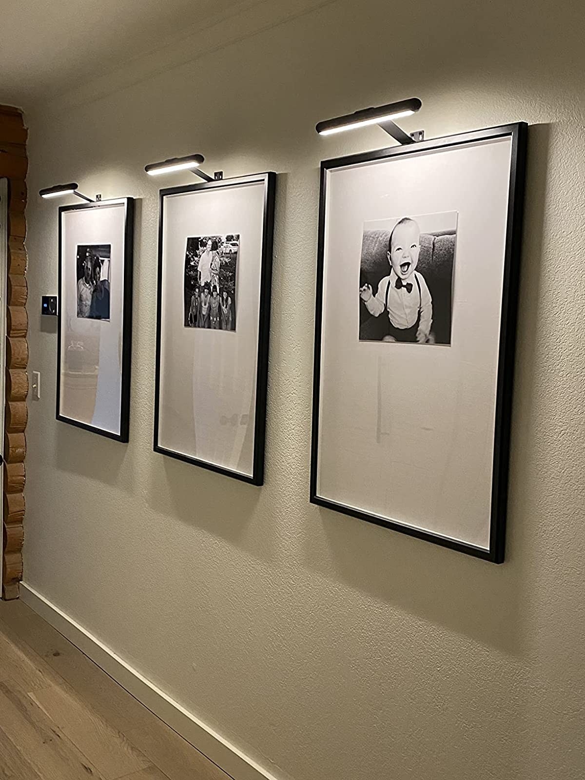 Reviewer image of picture lights above framed photos