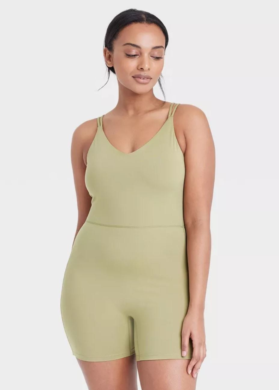 model wearing olive green short bodysuit