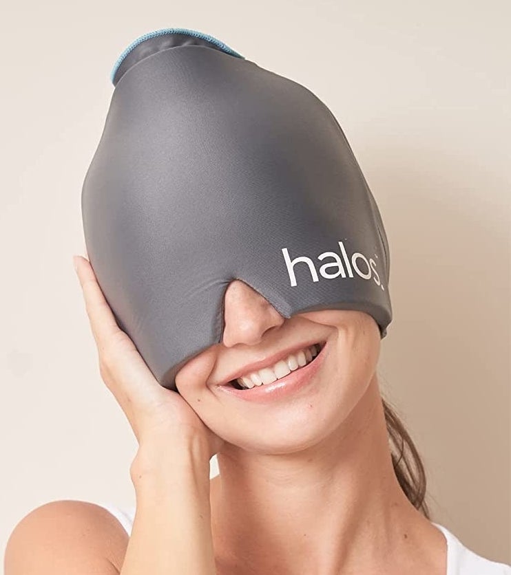 a smiling person wearing the cooling cap on their head