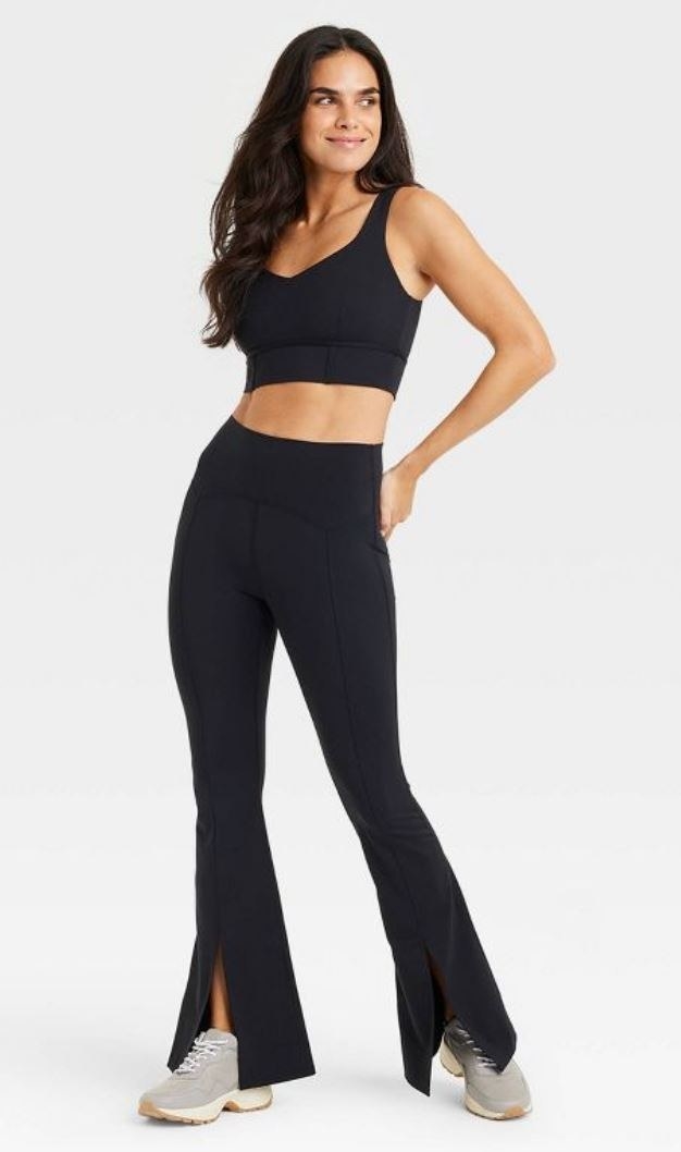 model wearing black split hem yoga pants