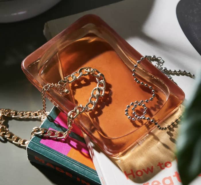 an orange glass dish with chains in it