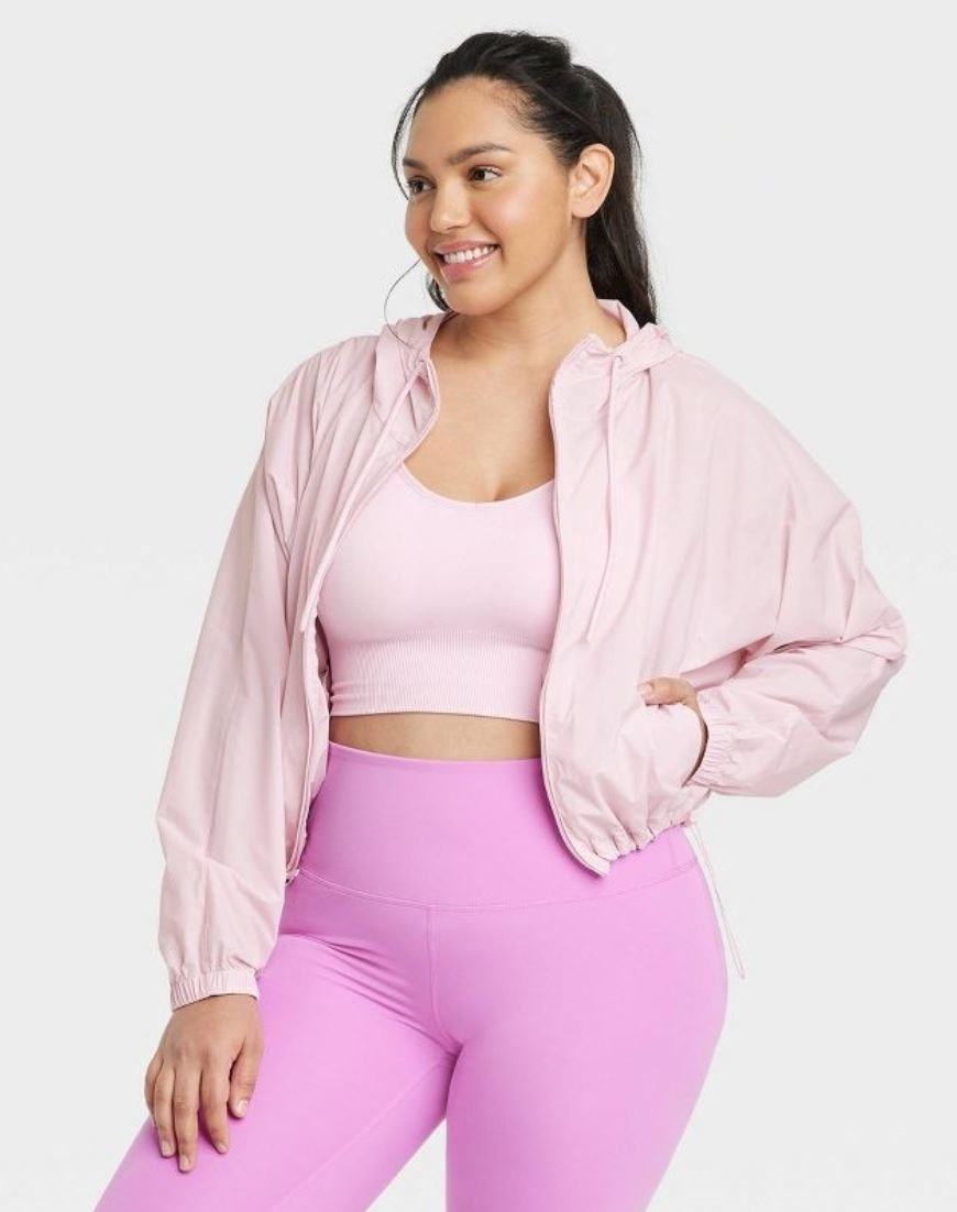 model wearing pink rain jacket