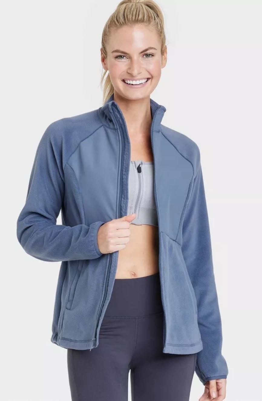 model wearing blue fleece zip up jacket