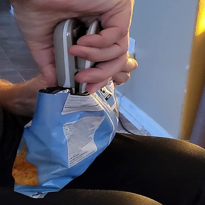 Reviewer sealing a chip bag with the bag sealer