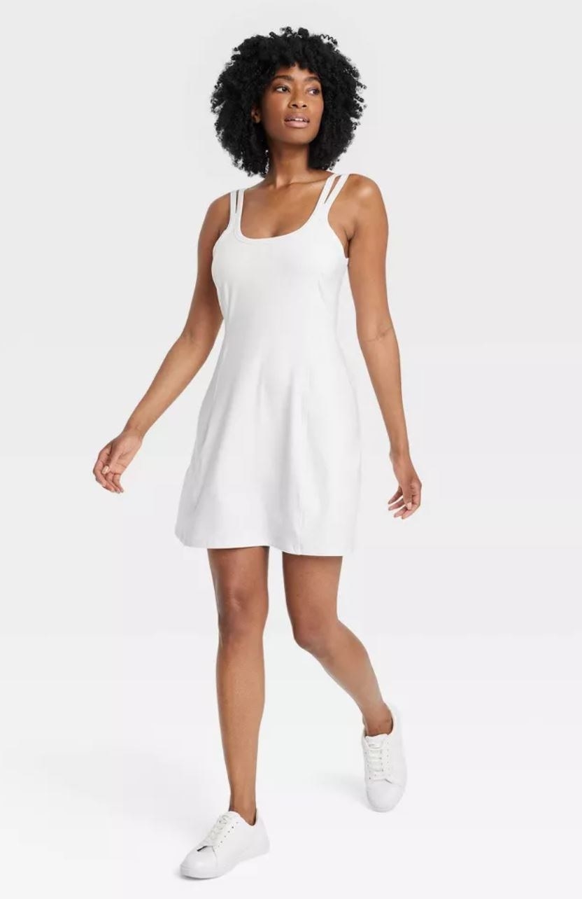 model wearing white knit exercise dress