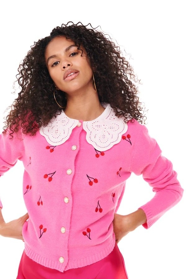 Model wearing pink and red cherry top with pink bottom